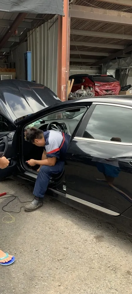 A Lim's mechanic working on a car in the shop